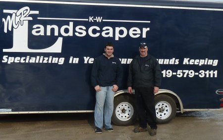 Photograph of John and Steve Corriveau standing in front of one of the Mr. K-W Landscaper trucks.